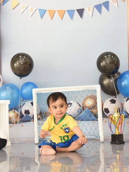 A future football star in the making. This wide shot shows the complete sports-themed setup, perfect for a birthday or milestone session.