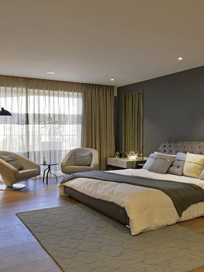 For a client who loves the feel of hotel suites, I designed this master bedroom for Mahindra Lifespaces. The sprawling 4000 sq. ft. space includes an inviting sitting area, blending the grandeur of a five-star hotel with the warmth of home.