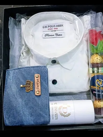 This classic gift hamper combines a personalized denim wallet with a crisp white shirt, deodorant, and a decorative rose with chocolates.