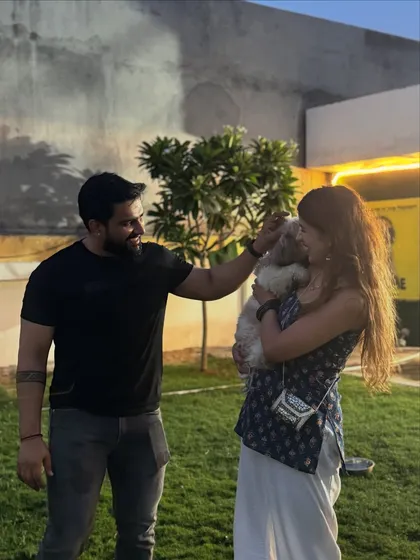 A sweet moment between a couple and their little dog in our yard.