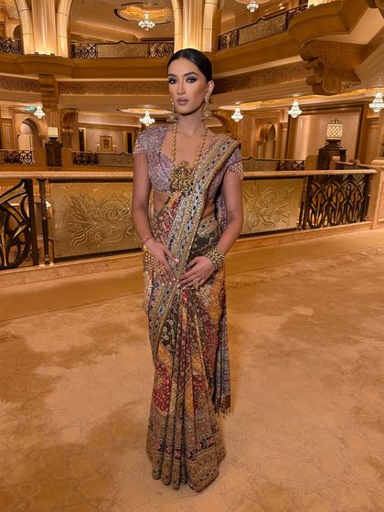 The full look, showcasing a unique Tarun Tahiliani saree. The sleek hair and bold makeup create a high-fashion, editorial feel.