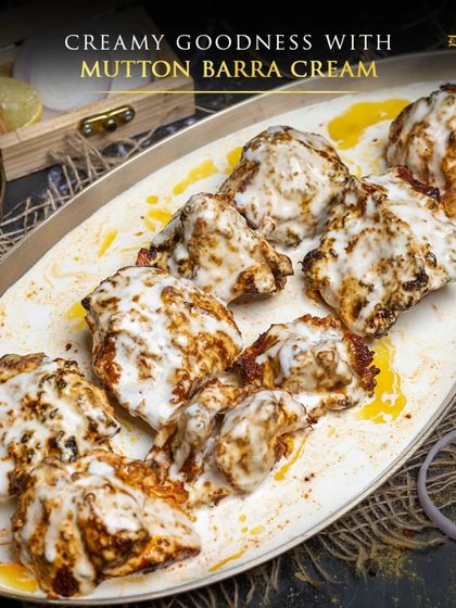 The creamy goodness of Mutton Barra Cream. This dish showcases tender mutton pieces on a platter, generously coated in our signature white cream sauce.