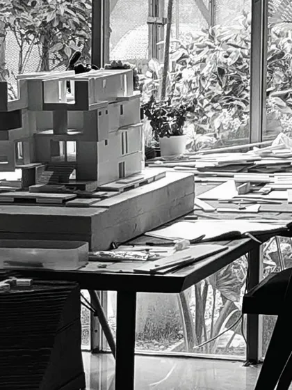 The model-making table, cluttered with tools and works-in-progress. This organized chaos is the sign of a creative space in full flow.