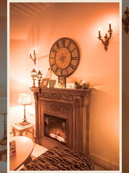 The fireplace area is one of the most loved spots, especially during cooler evenings. The warm glow and vintage clock create a timeless and comforting atmosphere.