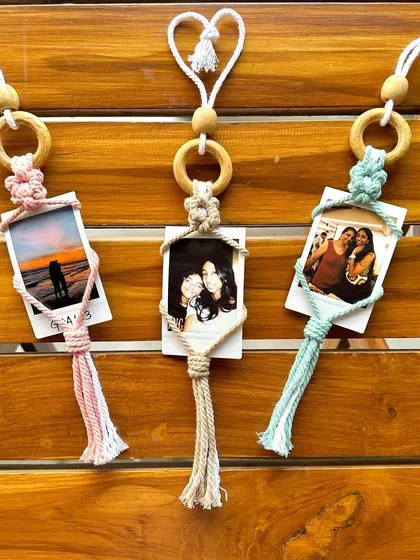 A set of our custom macrame polaroid holders, each with a unique photo and color scheme. They make thoughtful, personalized gifts for friends and family.