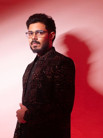 A classic portrait of the groom, looking directly at the camera with a confident and calm expression before his wedding.