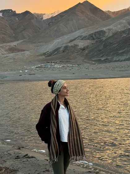 A quiet moment by a high-altitude lake in Ladakh as the sun sets. The crisp air and the golden light on the water create a feeling of profound peace and connection to the earth.