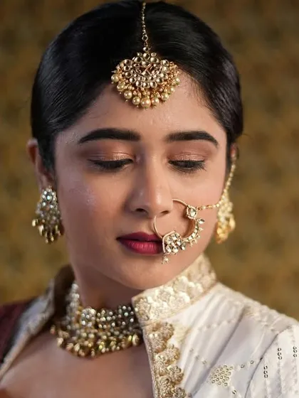 This look was inspired by classic glamour. I created a defined eye, a rich lip color, and paired it with a sleek braid for a sophisticated, retro-inspired bridal style.