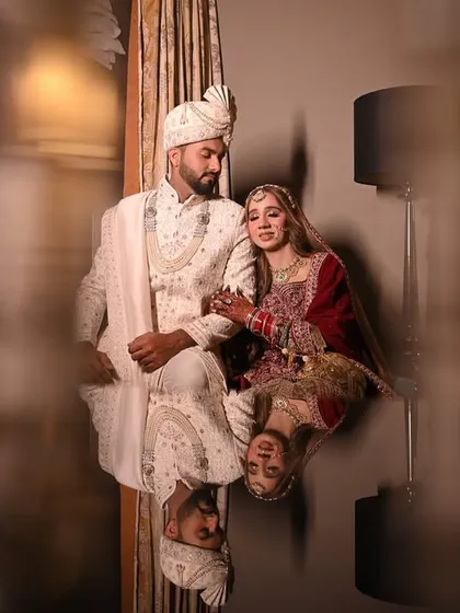 An artistic reflection shot of the couple, creating a unique and memorable wedding portrait. I love playing with reflections to add a layer of creativity and elegance to my photography.