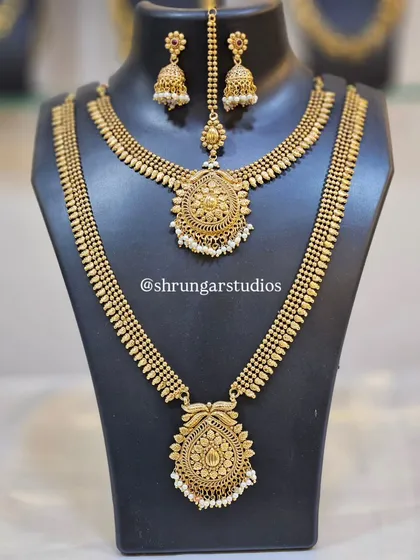 This matte gold finish bridal set offers a unique and elegant look, complete with a necklace, long haar, and maang tikka.