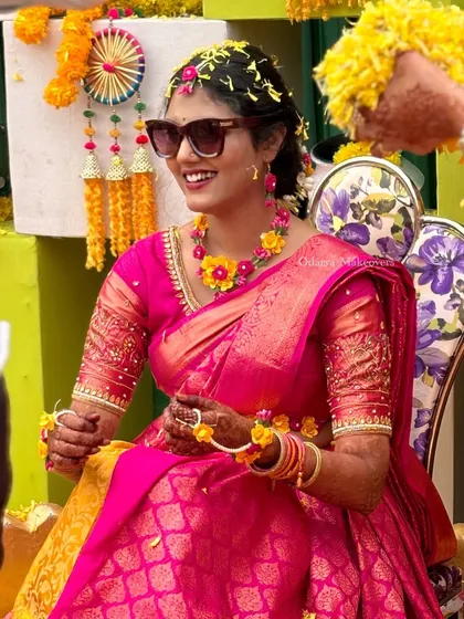 A happy, smiling bride enjoying her Haldi. The makeup is fresh and minimal, perfect for a daytime ceremony.