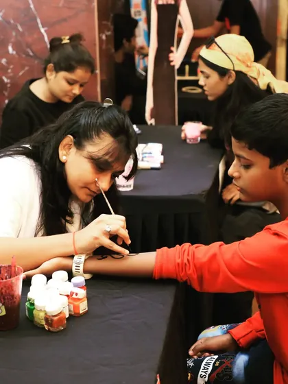 A temporary tattoo artist at a family-friendly corporate event. Offering engaging activities for all ages is part of how we ensure a successful and enjoyable get-together for everyone.