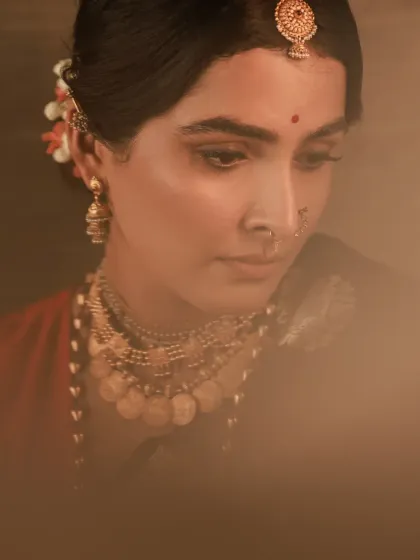 A series of moody and soulful portraits with a vintage feel. The model is styled in a handwoven saree and antique jewelry, with soft, diffused lighting creating a timeless and elegant atmosphere.