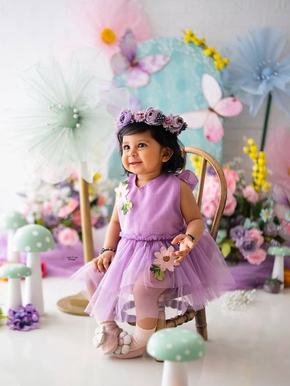 A sweet and calm portrait of the birthday girl in her pastel purple dress.