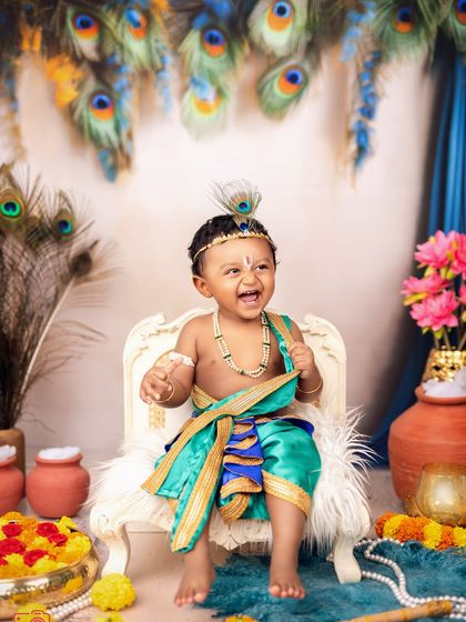 An exuberant laugh from our little Krishna. This photo captures the playful and mischievous spirit of the beloved character.