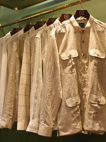 A collection of our custom-tailored shirts and shackets in neutral tones. These pieces, featuring varied textures and patterns, are perfect for pre-wedding festivities or as part of a layered ceremonial look.