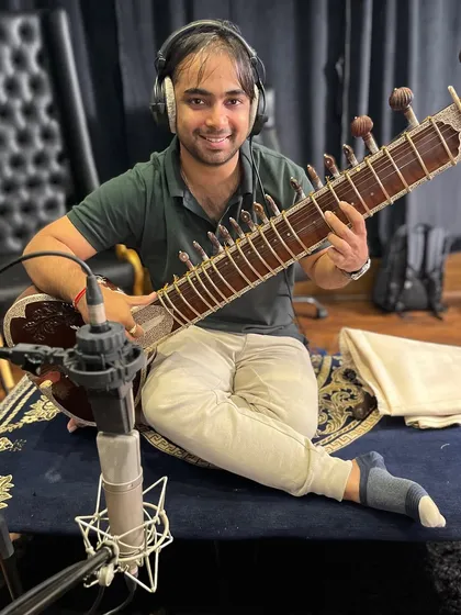 Smiling after a successful take during a recording session for an upcoming song. I find real joy in the collaborative process of bringing a composer's vision to life.