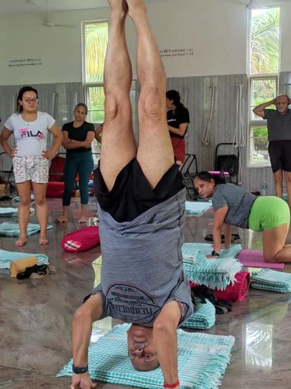 A student practicing Sirsasana (Headstand).