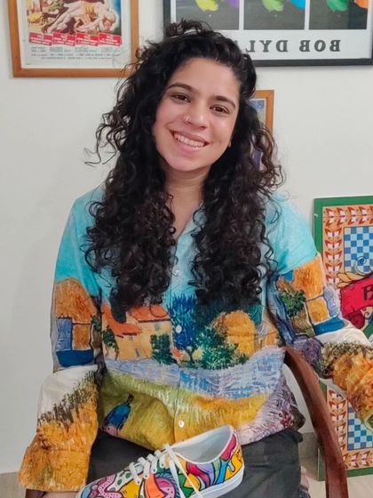 A candid shot of me in my studio, surrounded by my art and tools. This is my happy place.