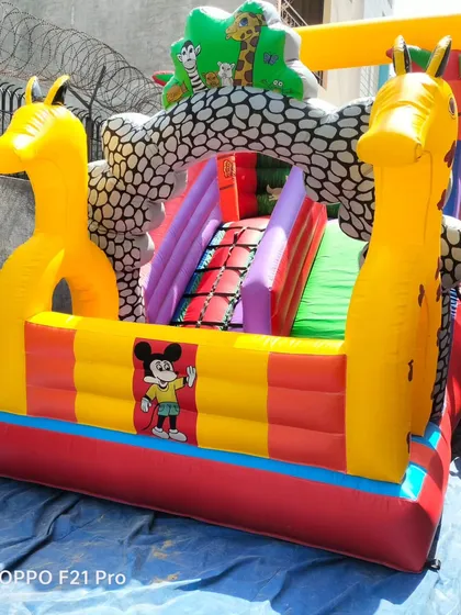 This jungle-themed bouncy features large inflatable giraffes at the entrance. It's a great example of how we can incorporate 3D elements into our designs.
