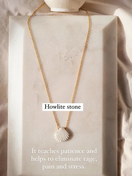 Another view of the 'saṅkha' howlite shell pendant. Its purpose is to bring a sense of calm and patience to the wearer.