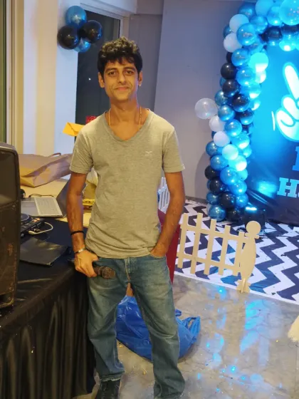 Posed and ready by the DJ console. I coordinate the music and announcements to create a seamless event experience.