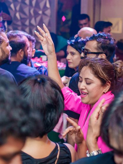 A partygoer dancing with joy at Happy Brew.