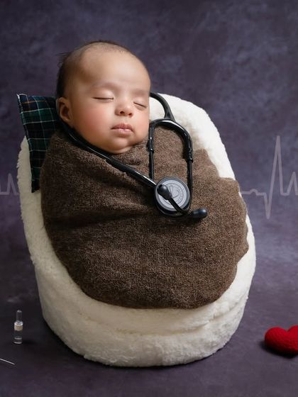 Listening to the rhythm of his own heart. This creative setup with a stethoscope and heartbeat graphic is a sweet nod to parents in the medical profession.