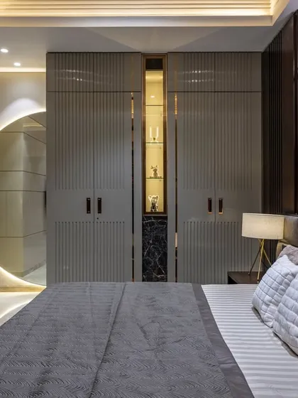 A duplicate of image 16, this view emphasizes the play of light and shadow on the textured walls and the sleek, integrated design of the storage and display areas.