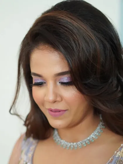 This downward glance shows the beautiful detail of the lilac glitter eyeshadow. It's a perfect example of how I love to play with color and texture to create a custom look.