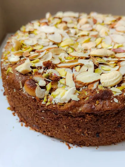 Here's another angle of my Whole Wheat Jaggery Cake. You can see the soft, moist texture of the cake itself, which is a perfect contrast to the crunchy nuts on top.