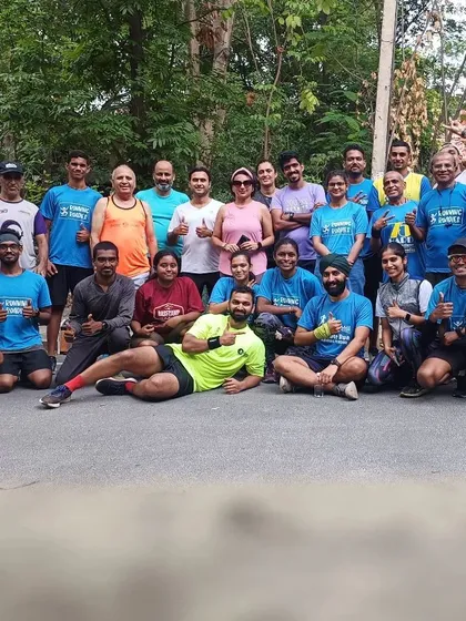 Welcome to the #HustleFam. We believe running is better with a crew, and this is ours. This photo captures the spirit of our community at a training meetup, where runners of all levels come together to support and inspire each other.