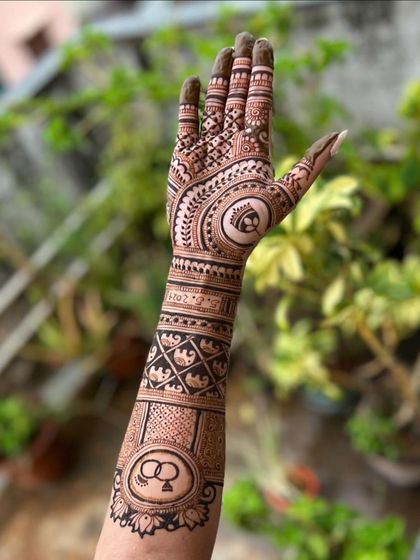 A single arm view of an engagement design, showcasing the initials, rings, and date woven into the pattern. This is a great option for a detailed yet not fully bridal look.