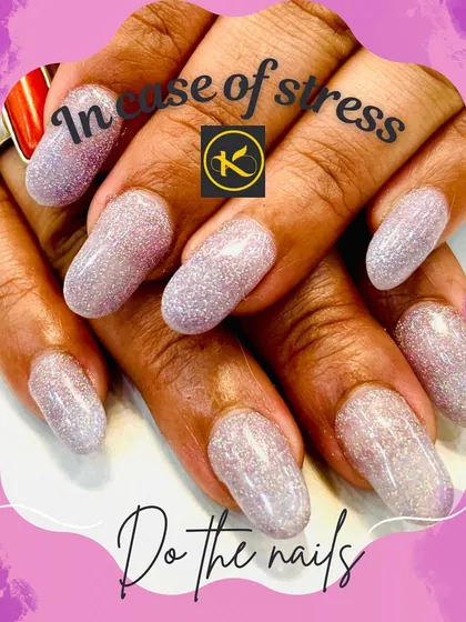 A full set of oval-shaped nail extensions completely covered in a fine, holographic silver glitter. This look is perfect for catching the light and adds a fun, dazzling effect to your hands.
