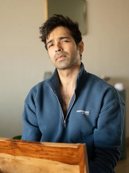 A straightforward, seated portrait that feels both casual and professional. This type of shot is essential for a versatile acting portfolio.