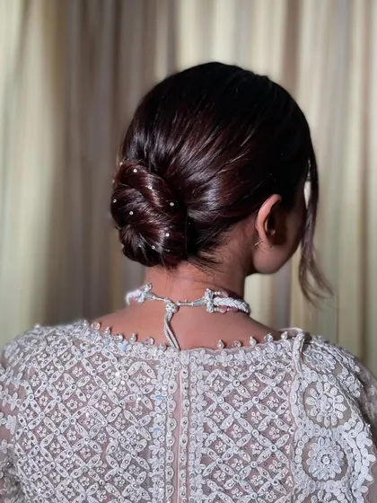 This is my signature Swarovski knot bun. It's a sleek, clean, and incredibly elegant updo where tiny crystals are scattered through the knot for a subtle, sophisticated sparkle.