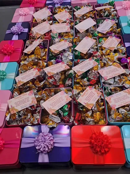 A vibrant collection of my budget-friendly tin chocolate boxes, available in many different colors with matching ribbons.