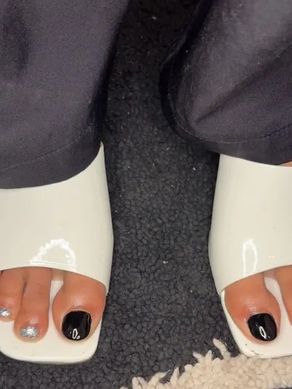 A black and silver glitter pedicure, perfect for a party.