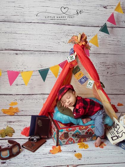 Our little world traveler is all packed and ready for an adventure. This setup, with a tiny tent, globe, and vintage-style luggage, tells a story of future journeys and big dreams.