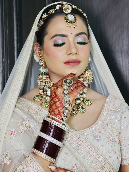 A close-up of the bride's makeup, with shimmery eyeshadow and a pop of green liner.