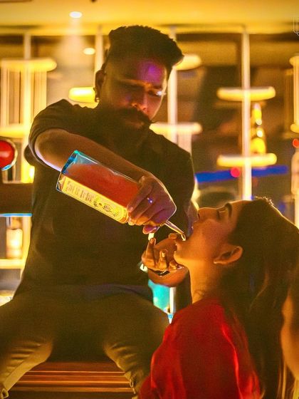 A bartender giving a guest a "long pour" shot at TYD. We make sure the bar experience is as fun as the dance floor.