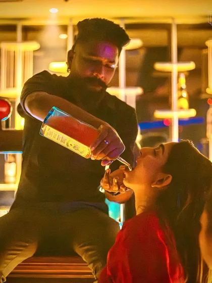 A bartender giving a guest a "long pour" shot at TYD. We make sure the bar experience is as fun as the dance floor.