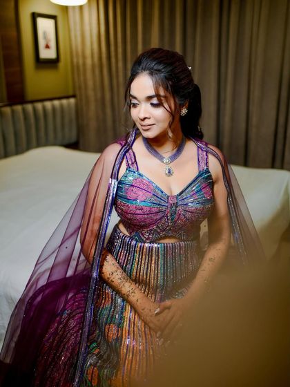 Purple, playful, and picture-perfect for Shloka's Sangeet. This colorful glam look features soft sparkle, bold hues, and joy in every detail.