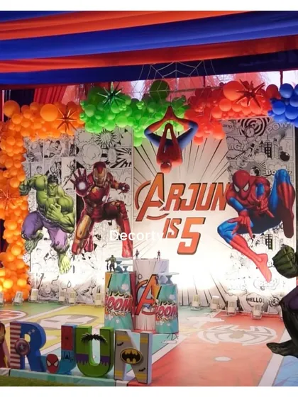 The full outdoor stage setup for the Avengers party, complete with a comic strip background and character props.