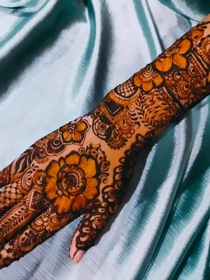 A close-up of the floral design on one hand, showing the intricate details.