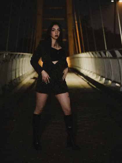 A powerful stance on the bridge, with the city lights in the background creating a beautiful bokeh effect.