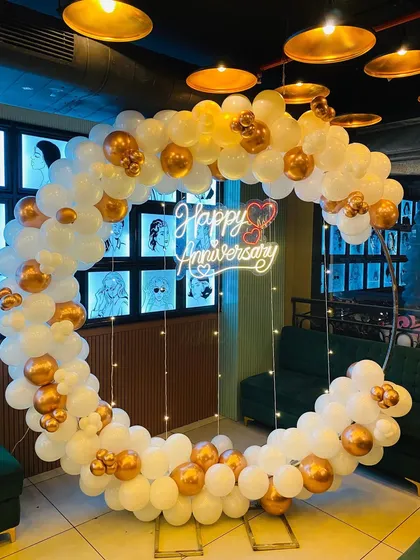 The beautiful anniversary arch glowing under the venue lights, ready to be the centerpiece of the celebration.