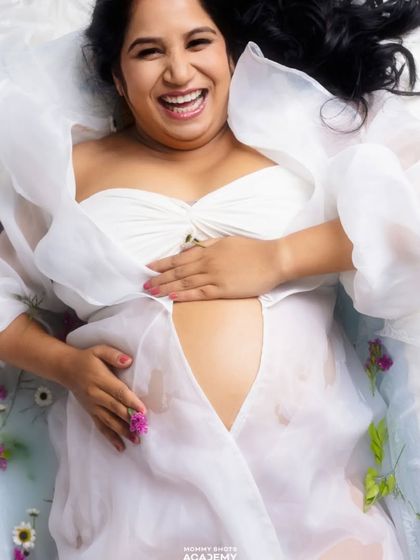 A joyful and candid milk bath photo, showcasing a creative and popular maternity concept.