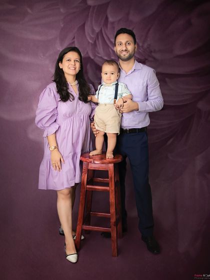 A lovely family portrait in shades of lavender. The coordinated colors and happy smiles make this a beautiful and classic family photo.