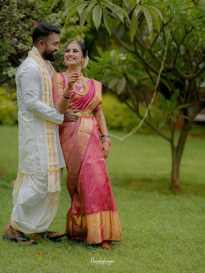 A playful and romantic moment in the garden. The bride's happy expression and their gentle embrace make this a heartwarming couple portrait.